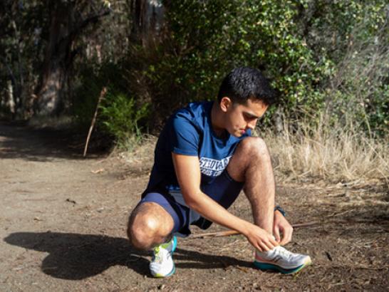 Cross Country athlete prepares for a trail run.