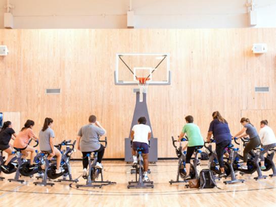 Students working out during a Group X session in the Alumni Gym.