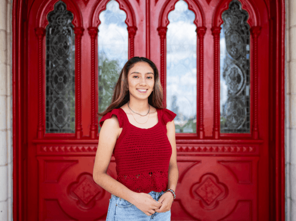 Hailee Alvarez poses in front of Main Building