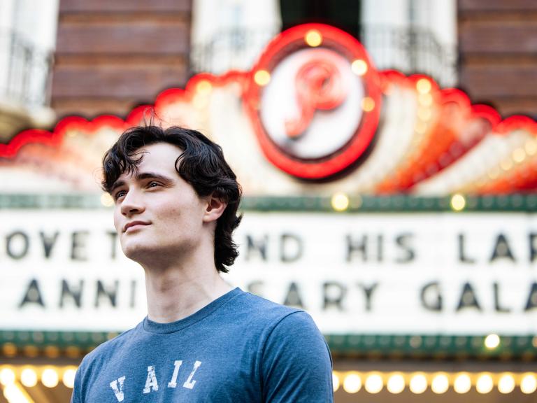 Sam McFarland poses in front of the Paramount Theater in downtown Austin