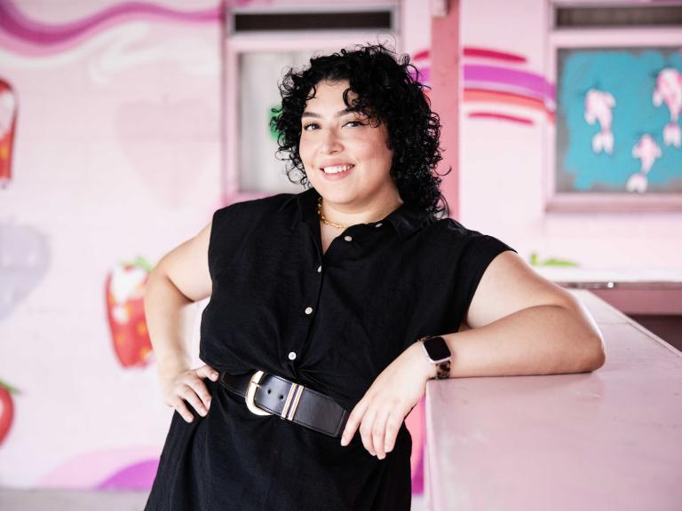 Fabiana Melendez poses in front of a street mural in Austin, Texas