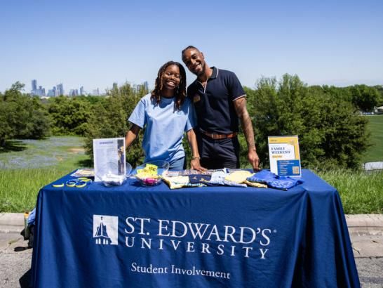 Student Involvement standing outside main building encouraging students to sign up clubs and organizations.