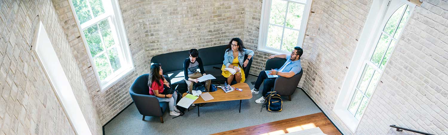Student study together in lounge setting in Holy Cross hall 