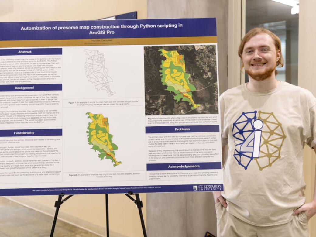 An i4 student stands by their research poster board.