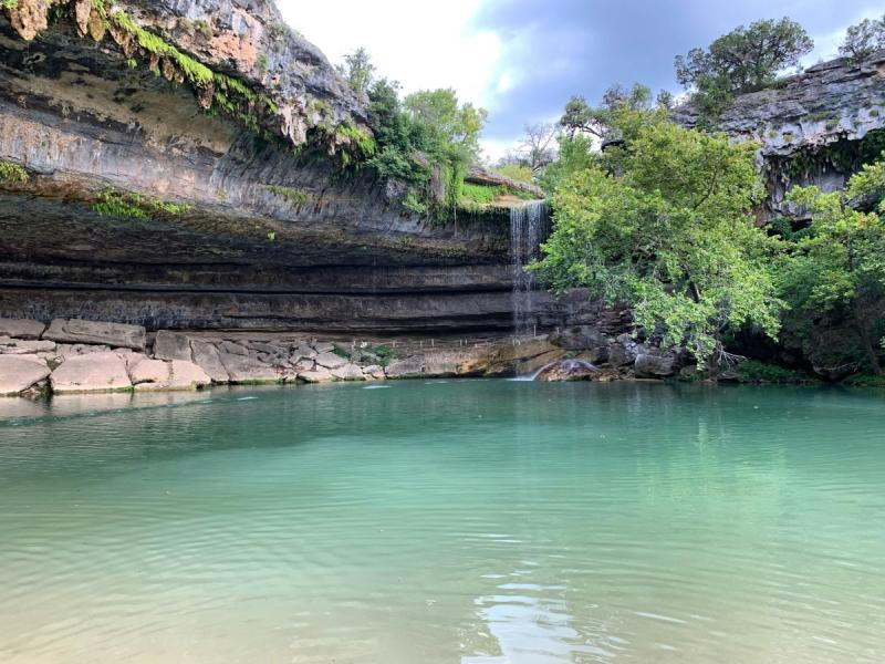 Water fall viewed over a shallow pool.