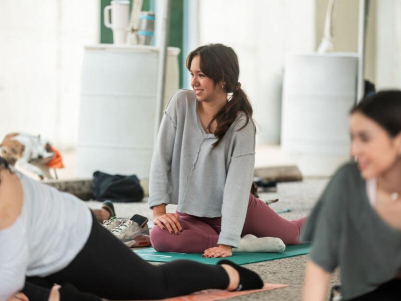 Students taking goat yoga as part of LiveWellSEU