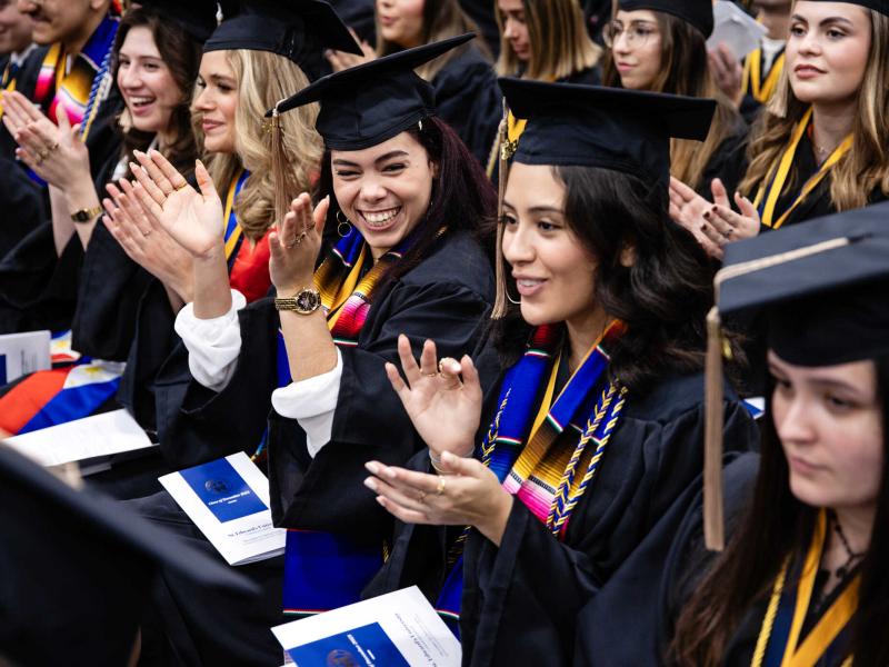 Students clap at the December 2023 Fall Commencement