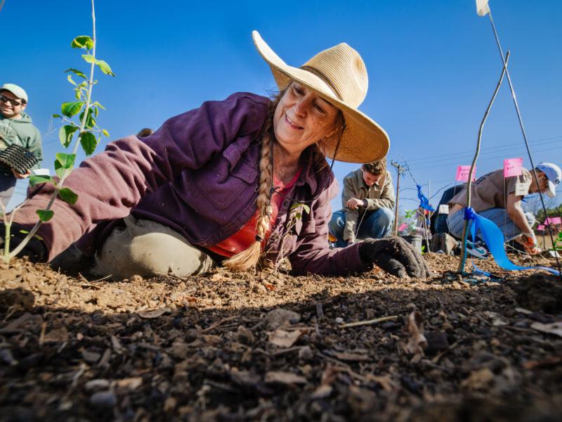 Hilltoppers and supporters gather in front of the Carriage House to celebrate the grand opening of the reimagined space for The Kozmetsky Center.