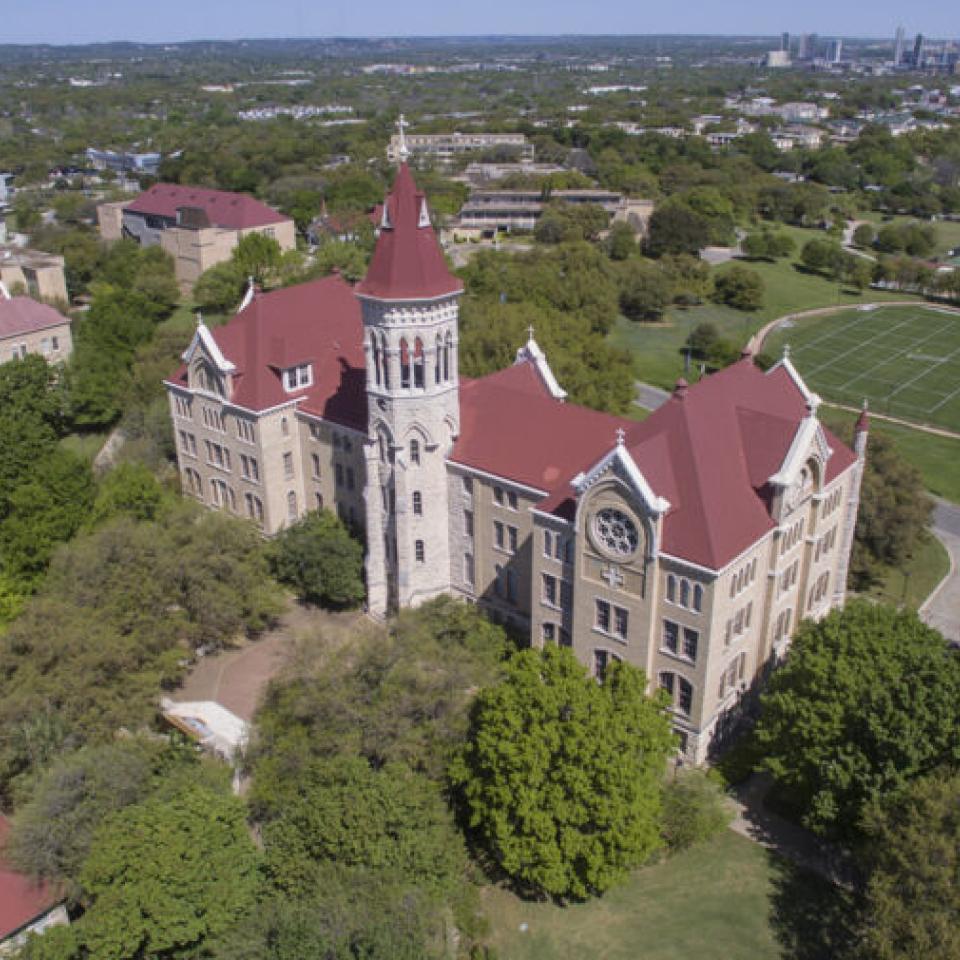 Aerial view of the St. Edward's University campus with the downtown skyline in the distance