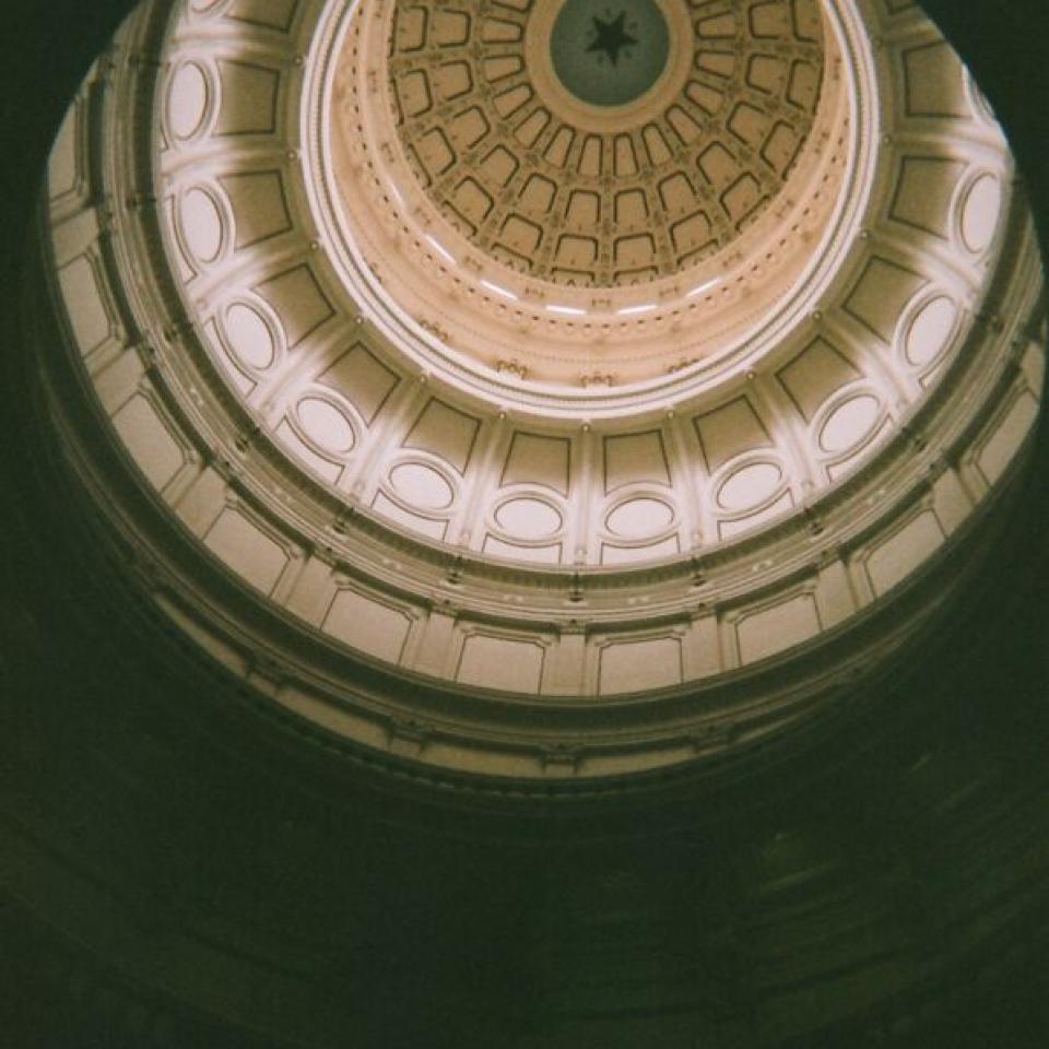 A view of the Texas Capitol Rotunda, looking up from ground level.