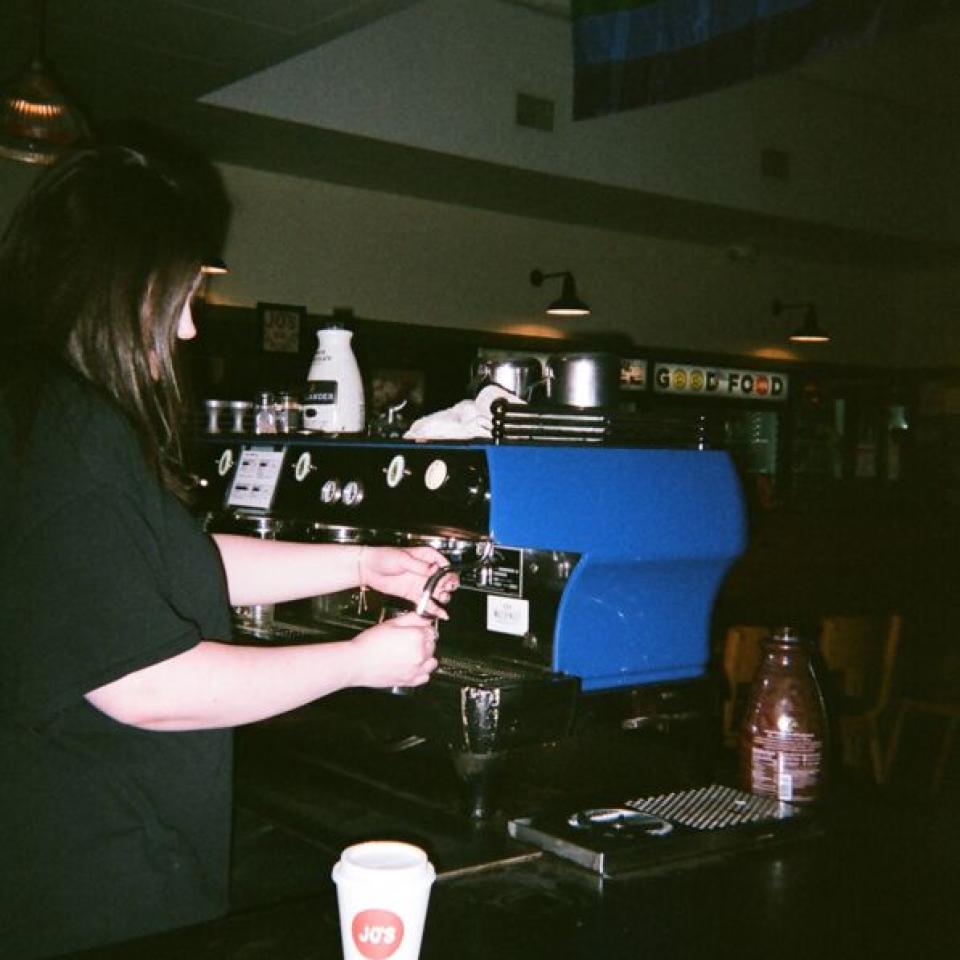 A barista makes a coffee drink at Jo's.