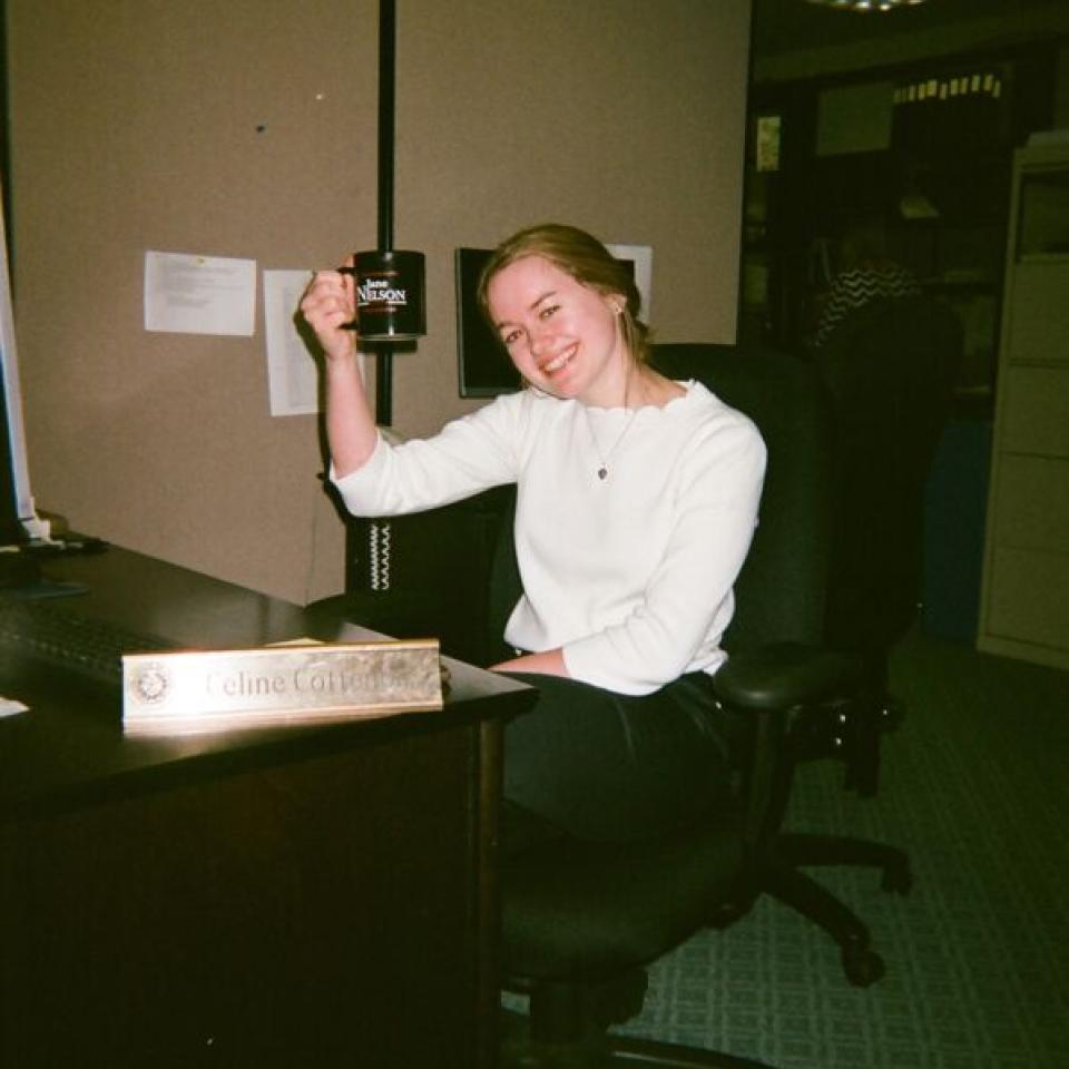 Celine Cottenoir sits in her office at the Texas State Capitol, holding a mug.