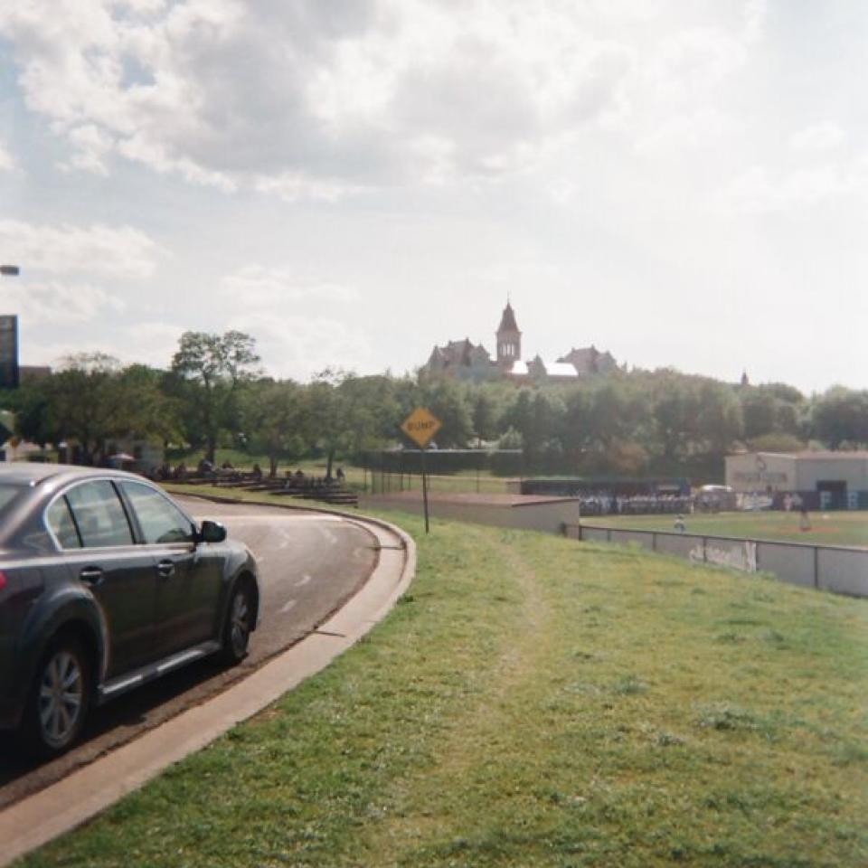 A view of Main Building and campus from a road.