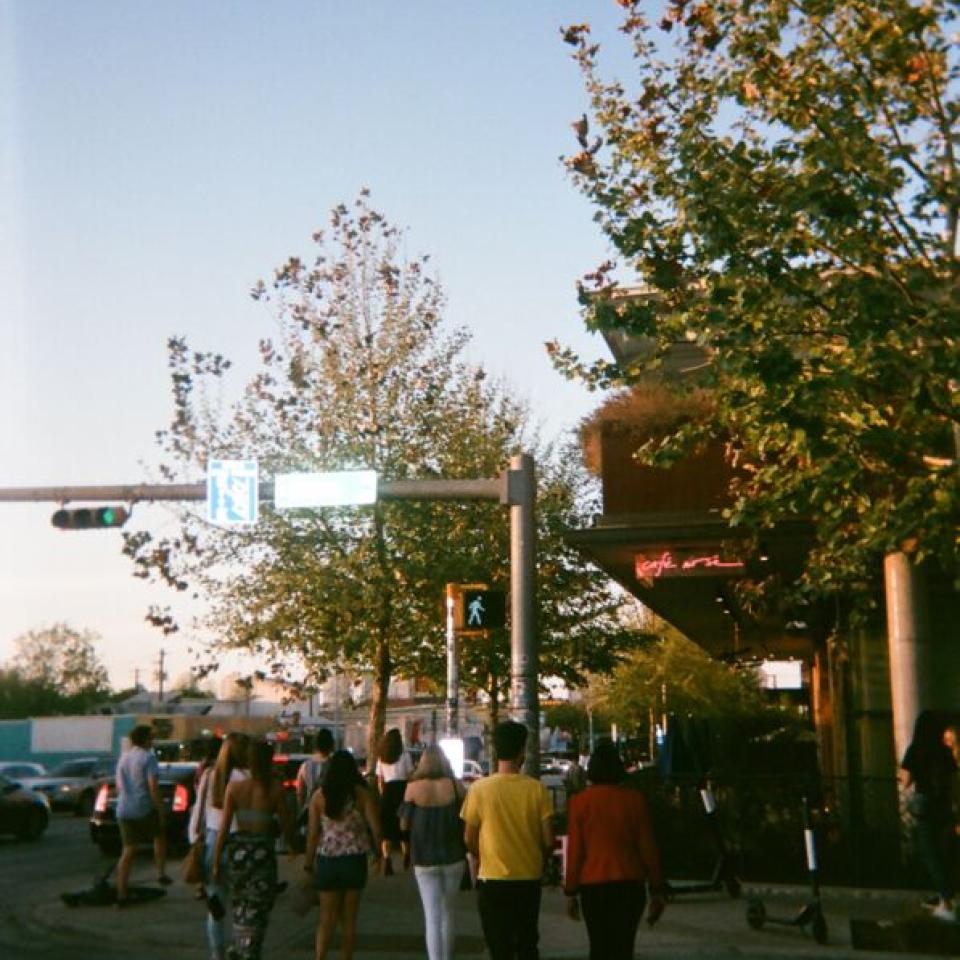 People cross the street at an intersection on South Congress Avenue.