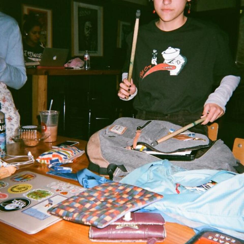 A student hangs out with drumsticks in Meadows Coffeehouse.