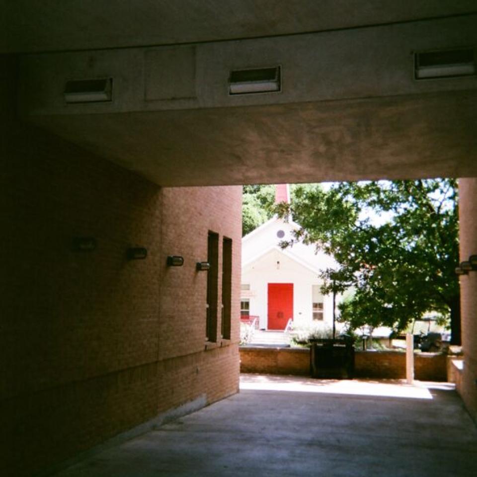 Our Lady Queen of Peace Chapel is seen through Trustee Hall's breezeway.