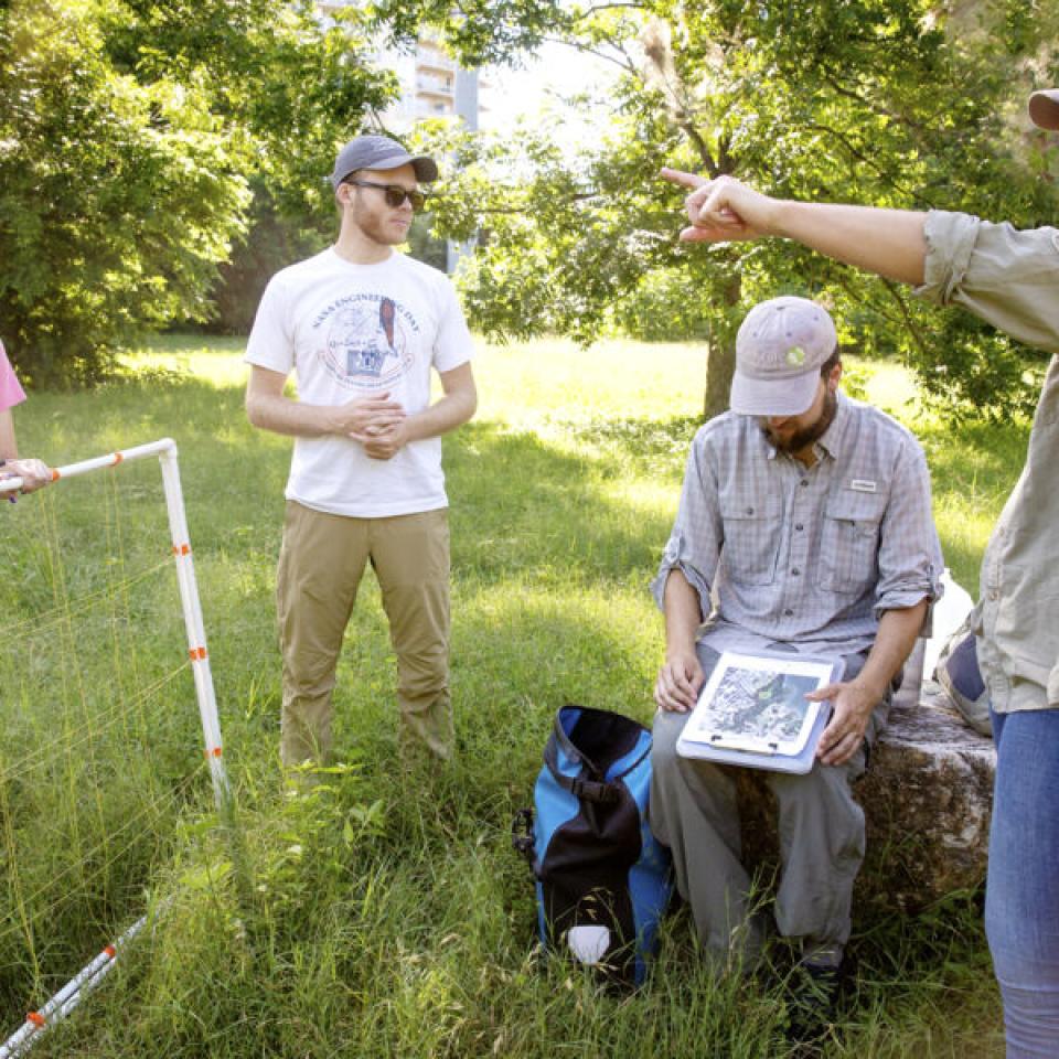 Stella Cunningham, left, listens to instructions for field work from teammates.