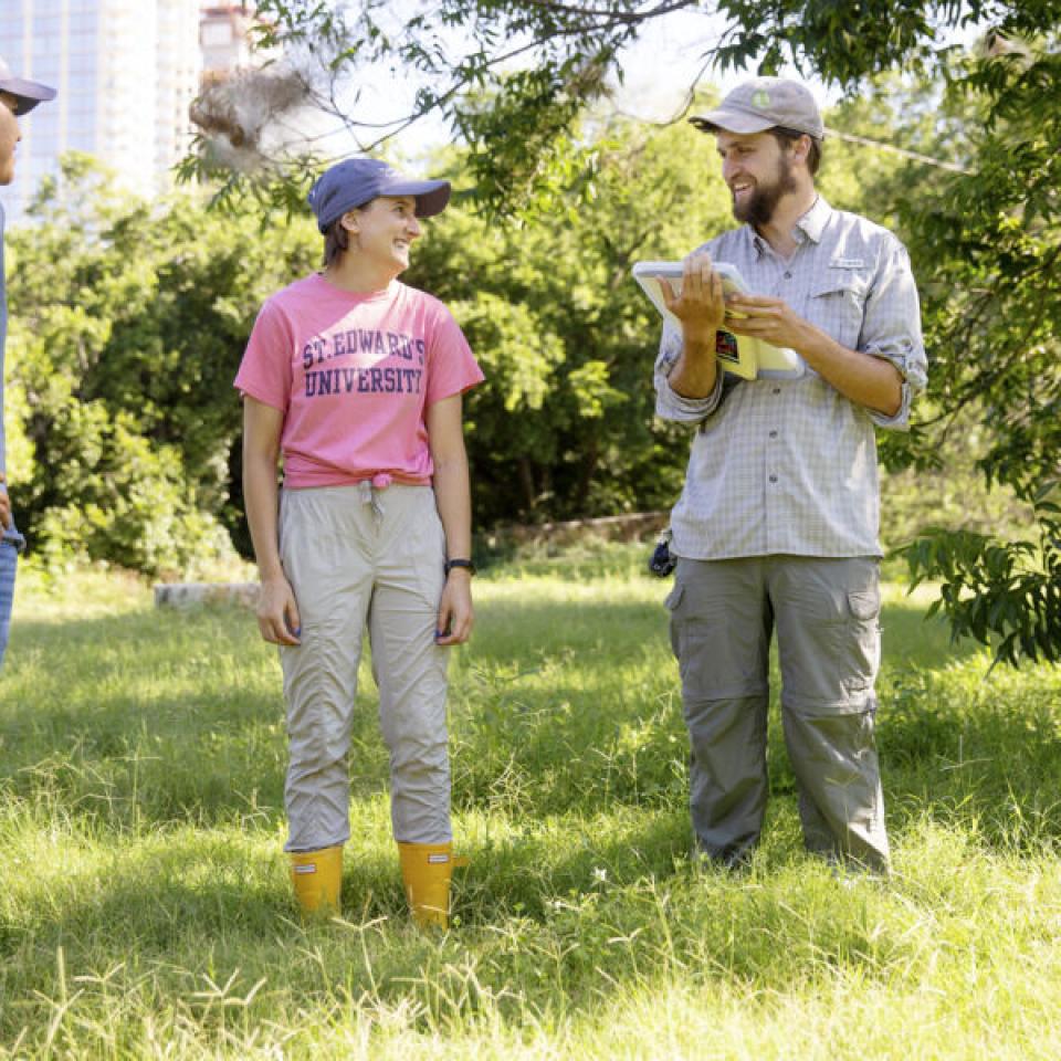 Stella Cunningham, center, talks with teammates while taking a break from field work.