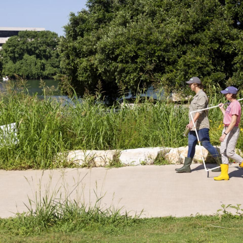 Stella walks with a teammate while conducting field research.