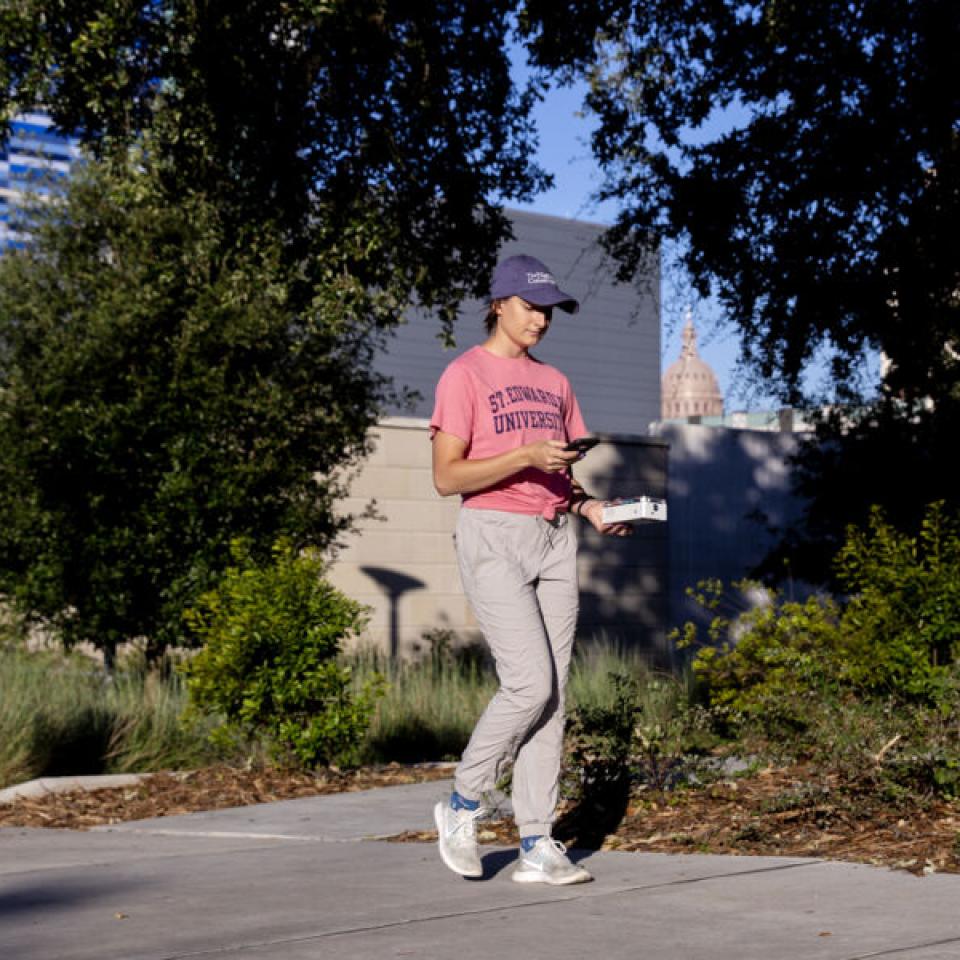 Stella Cunningham walks around downtown while doing field research.