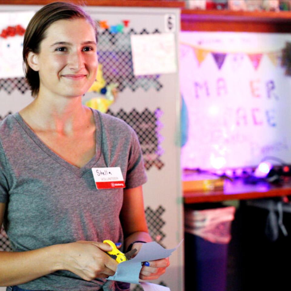 Stella Cunningham works on a craft while volunteering at the Thinkery.