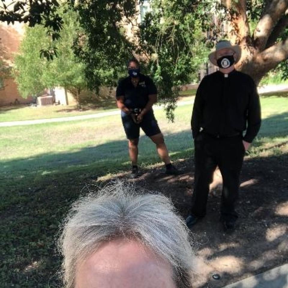 Lisa Kirkpatrick, Ellisha Isom and Father Peter Walsh wear face masks and take a selfie.