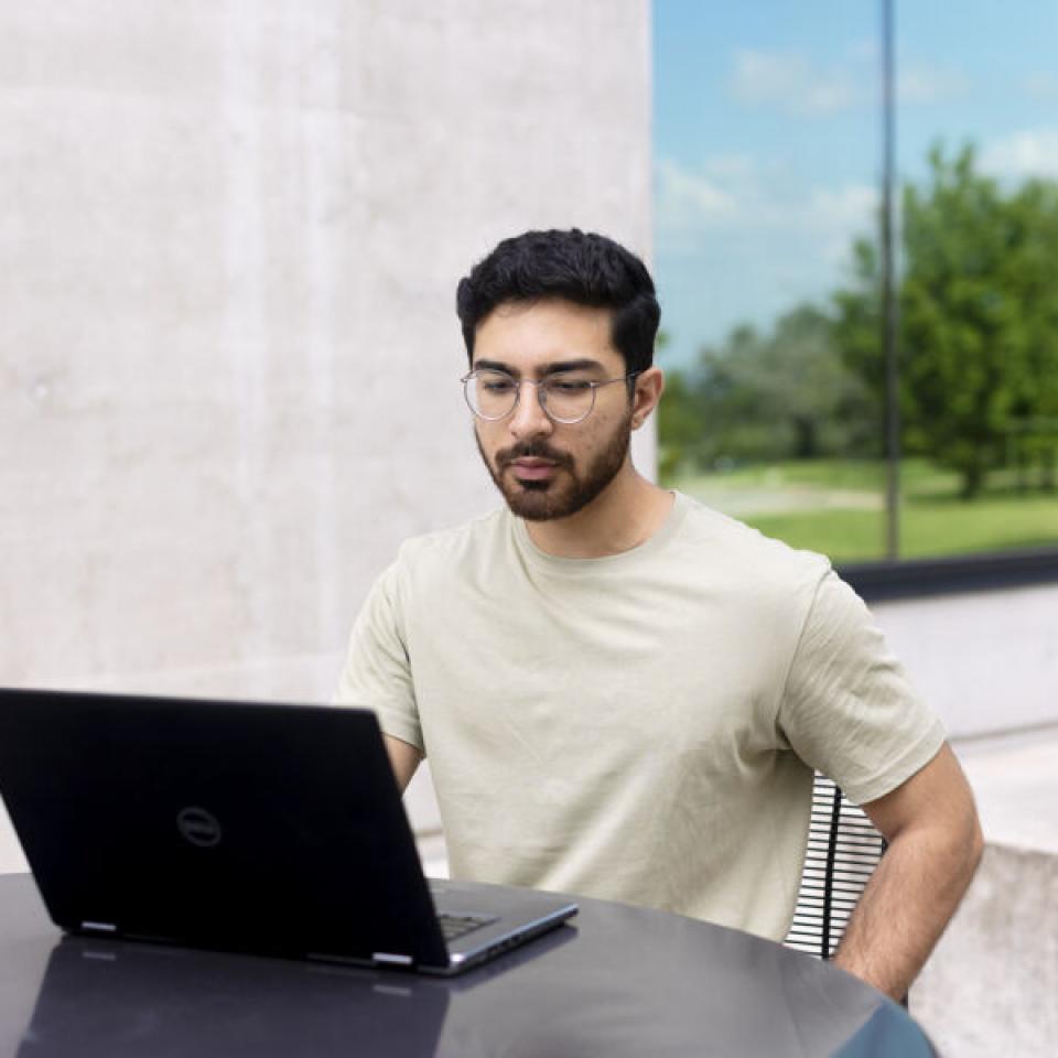 Sabur Khan studying in front of a laptop 