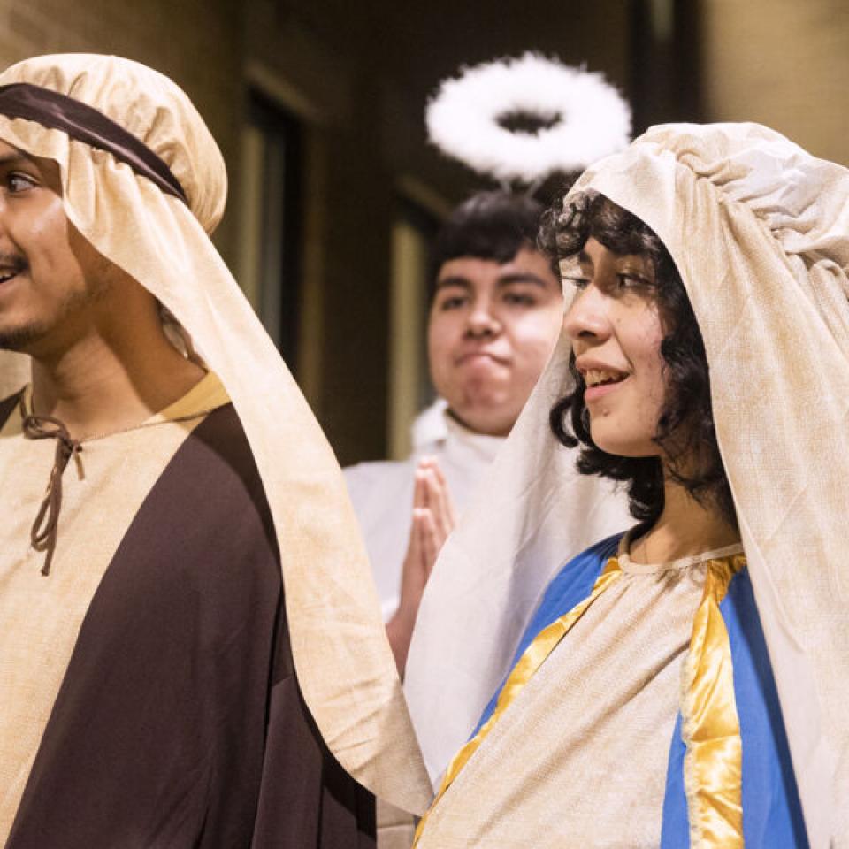 Three people dressed up as Mary, Joseph, and an Angel