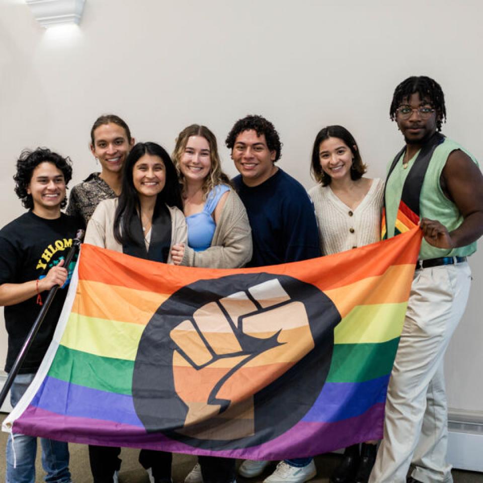 Students holding the "Pride Flag" in support of LGBTQIA+ rights.