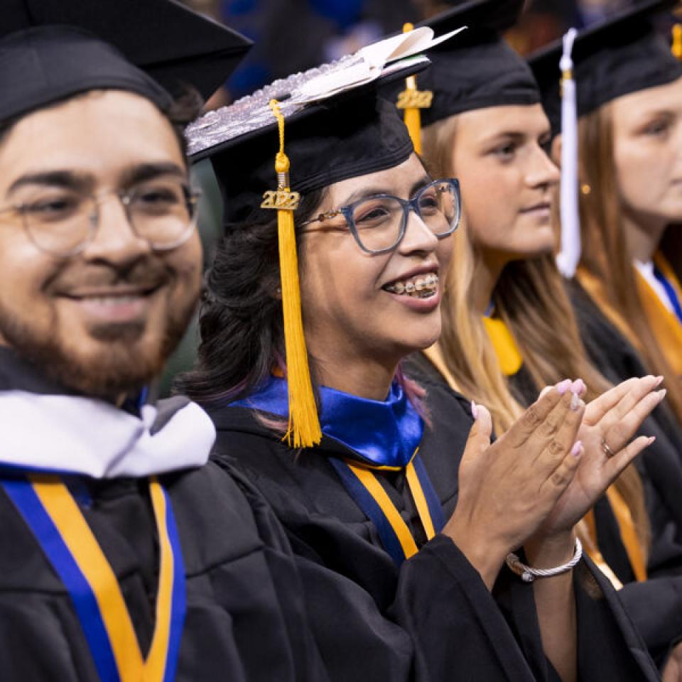 Sabur Khan at graduation with 4 students 