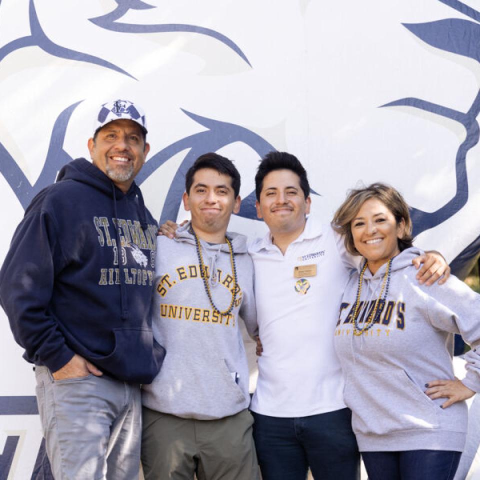 Luke and Ethan Tobias stand with their parents for a photo during Homecoming.