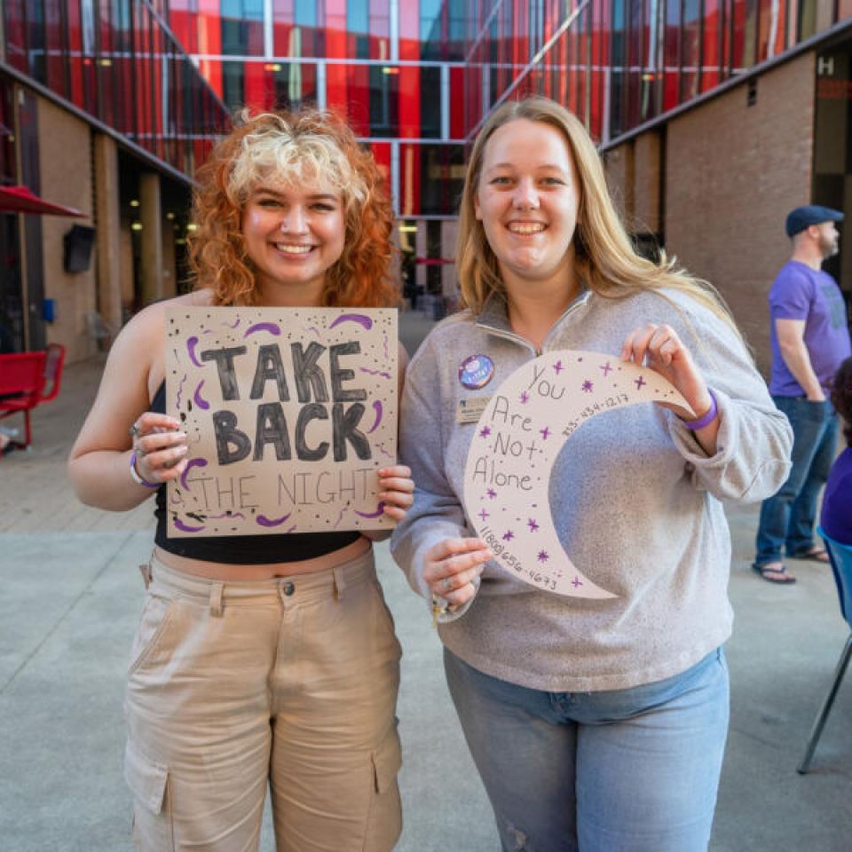 Students holding signs and participating in Take Back the Night event at St. Edward's.