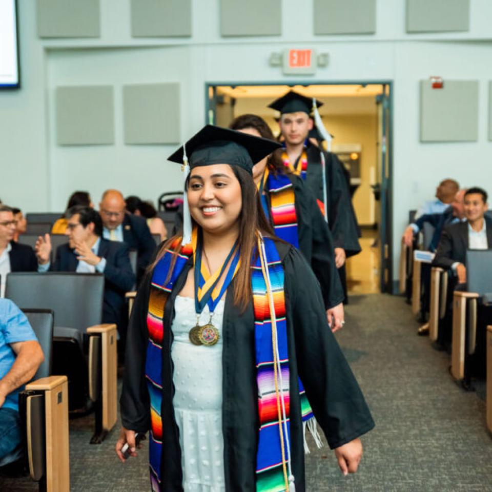 Camp students at graduation in cap and gown 