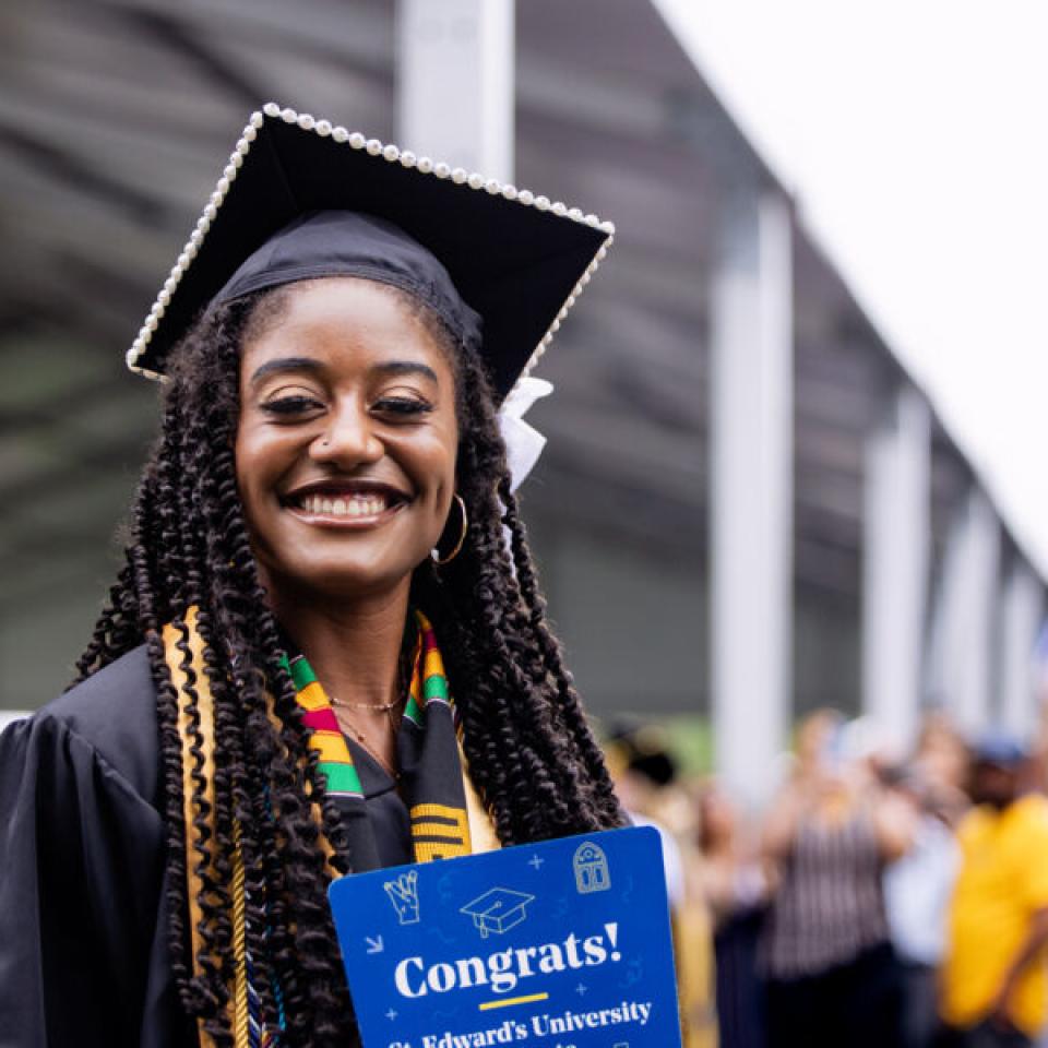 Graduating senior poses for a photo at commencement.