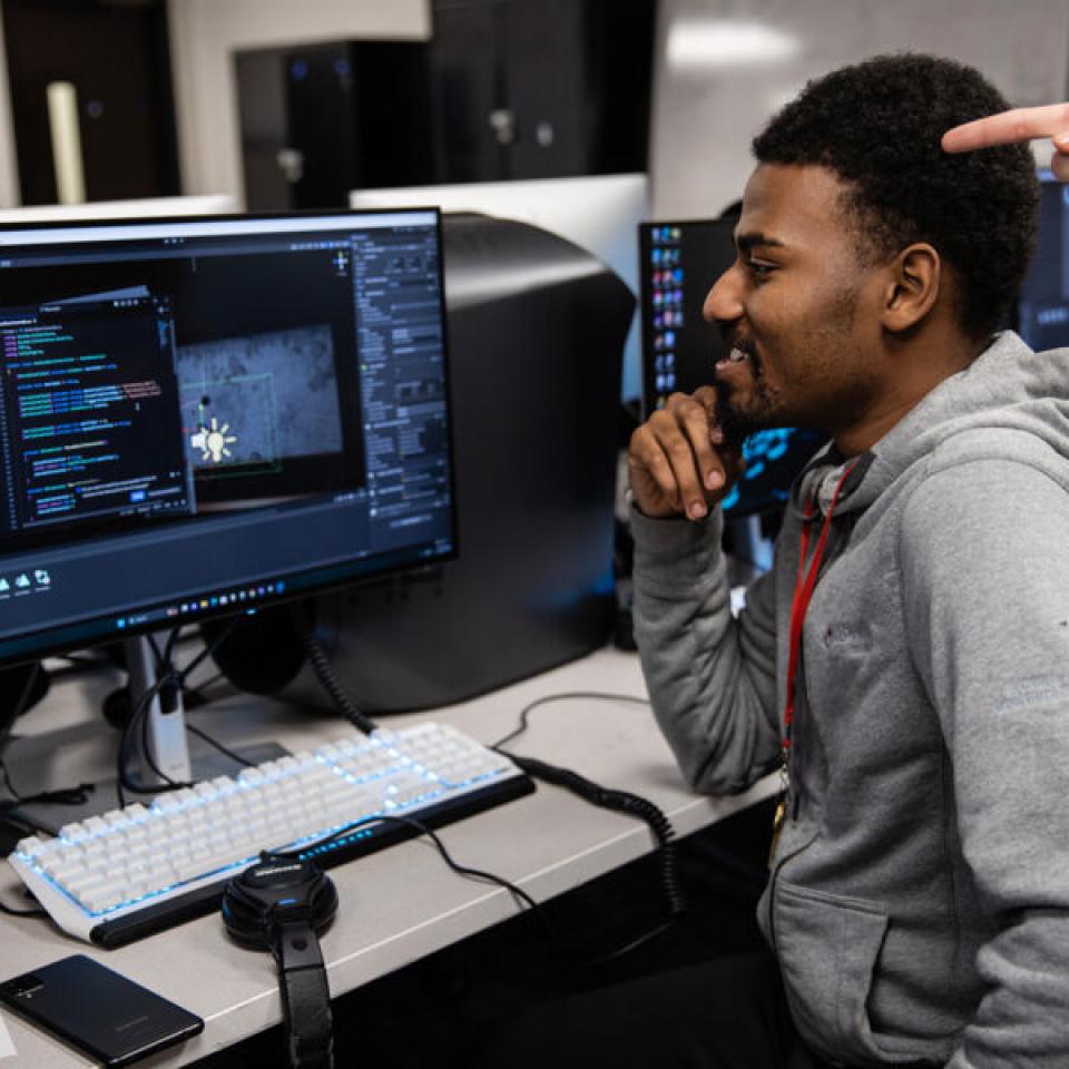 Student learning at the computer about coding for software development.