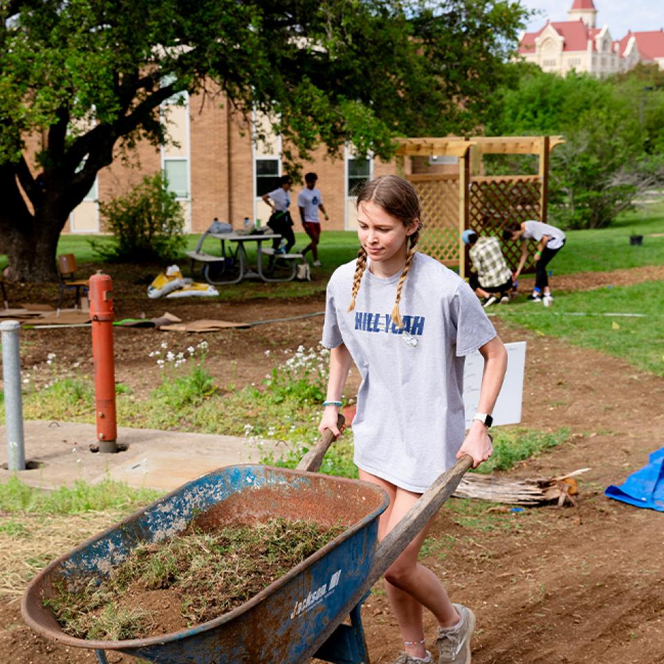 Student helping with upkeep on our beautiful grounds during Big Event 2023