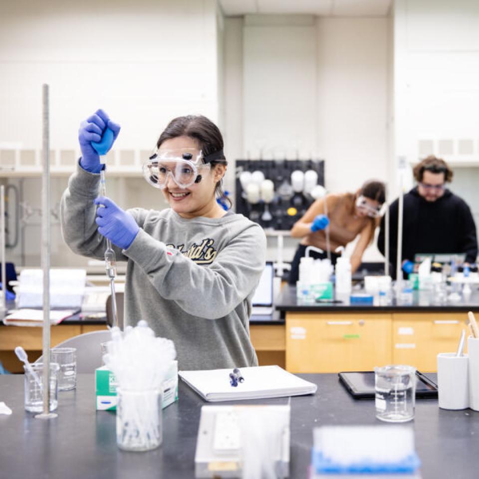 Student conducting a science experiment in class.