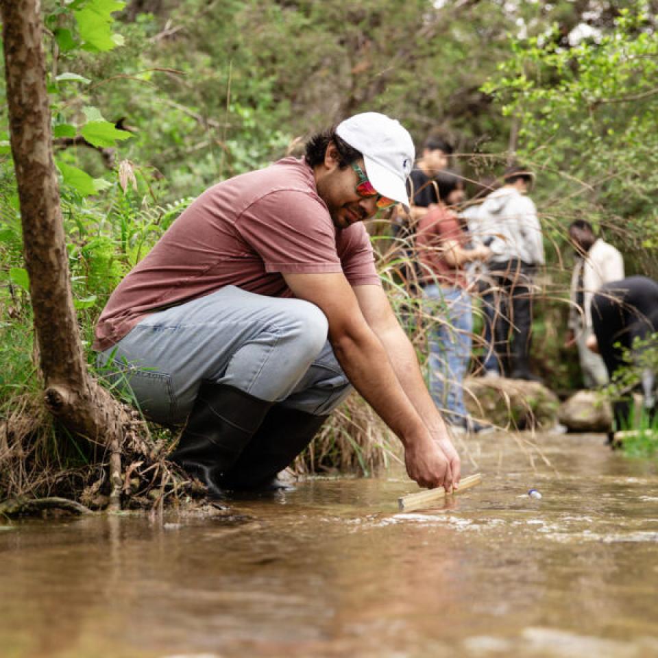 Student conducting research in the creek at the Wild Basin Wilderness Preserve.