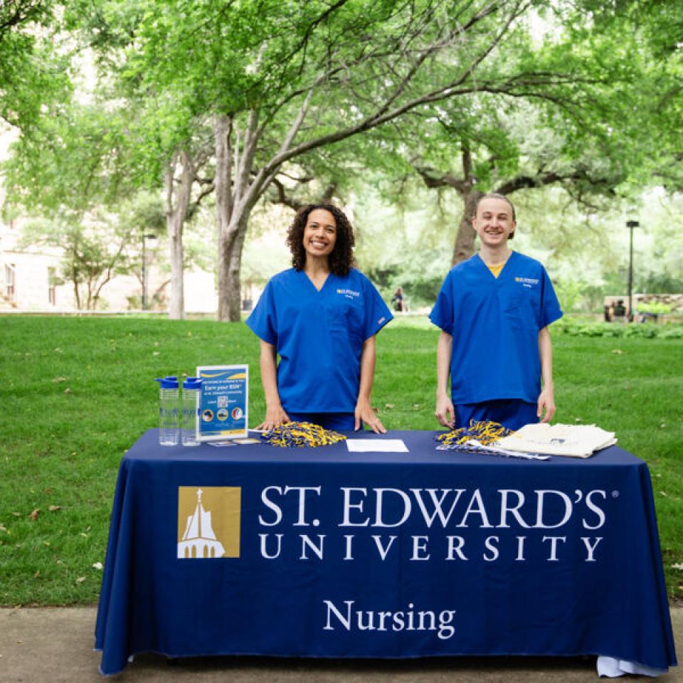 Nursing students at a booth giving people information on the new program