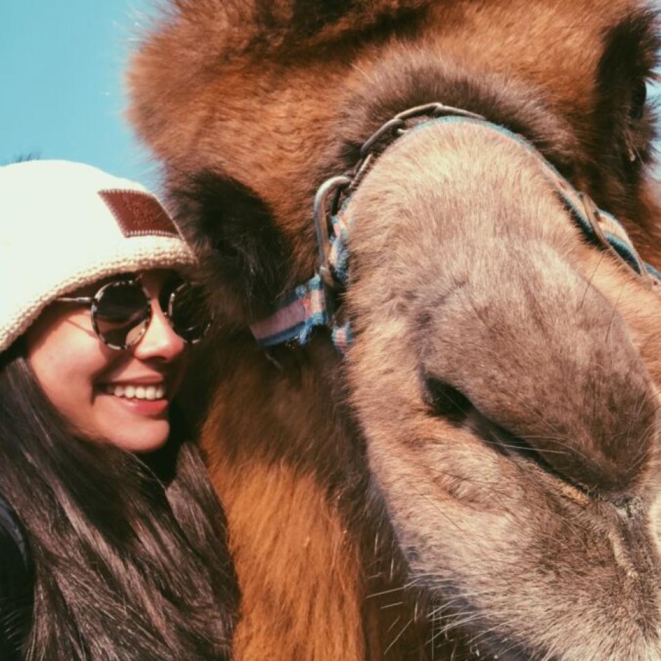 Aida Domingo takes a selfie with a camel.