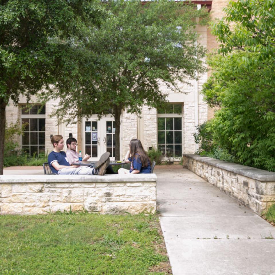 Students sitting outside Jacques Dujarié Hall