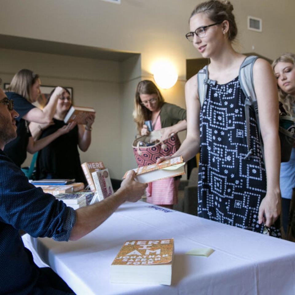 Jonathan Safran Foer signing a students book