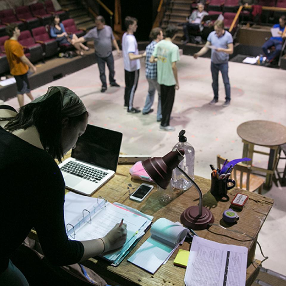 Theater manager working on scripts for the production