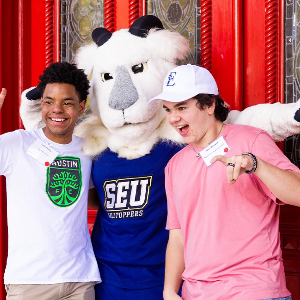 Prospective students posing for a picture with Topper the Goat