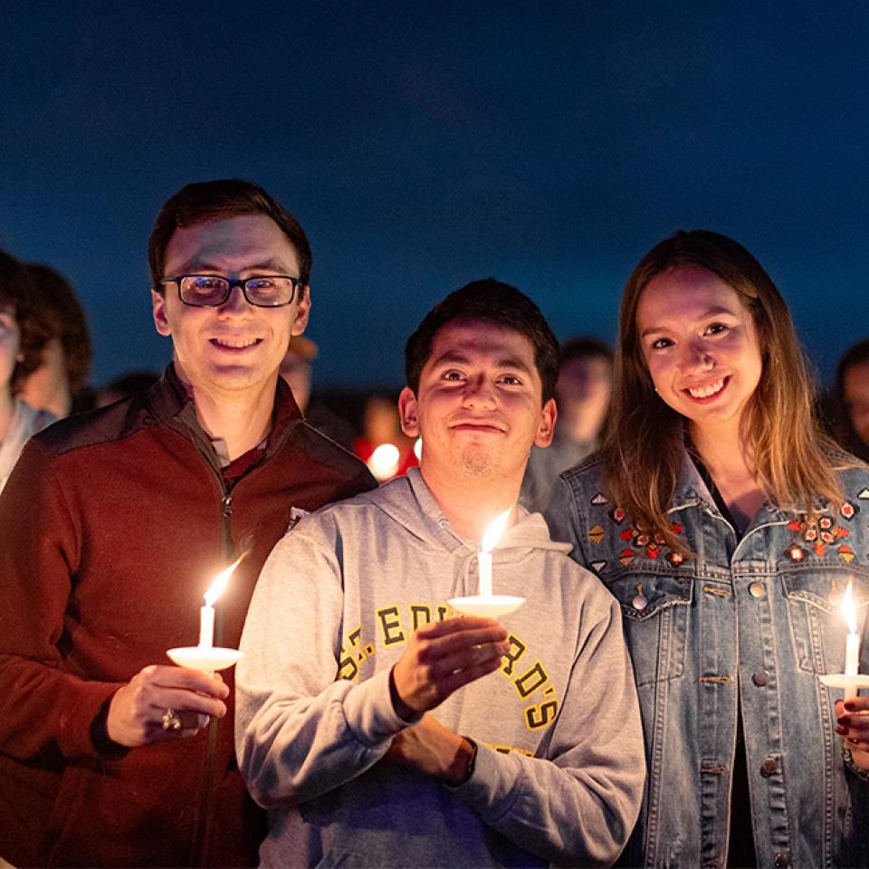 Students holding candles at the Fall 2022 Festival of Lights