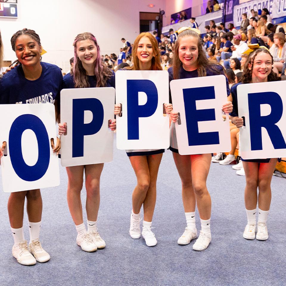 President Montserrat Fuentes posing with the St. Edward's University Cheer team