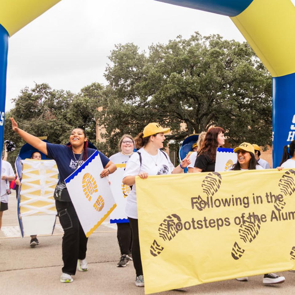 Students who study forensic science walk the parade