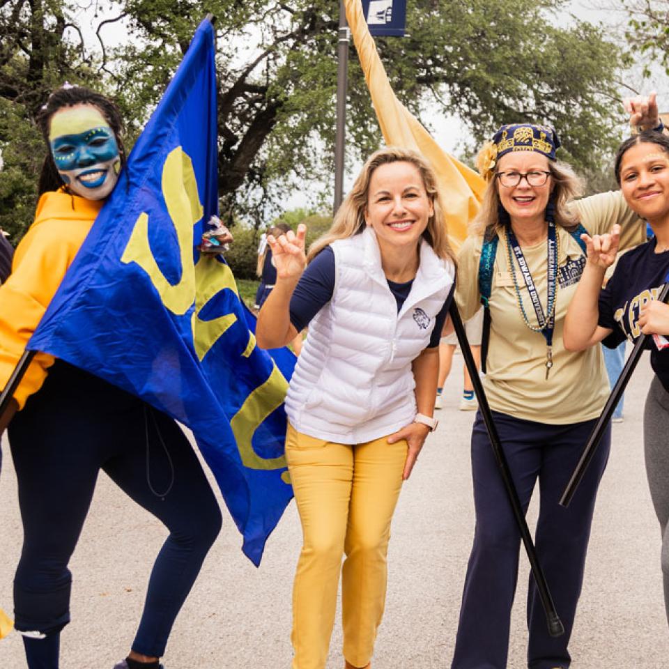 President Fuentes poses with Dr. Kirkpatrick and spirited students