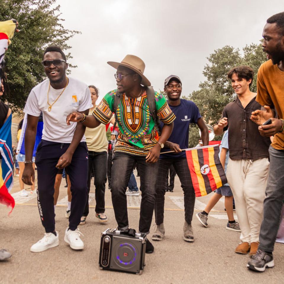 International students walk the homecoming parade