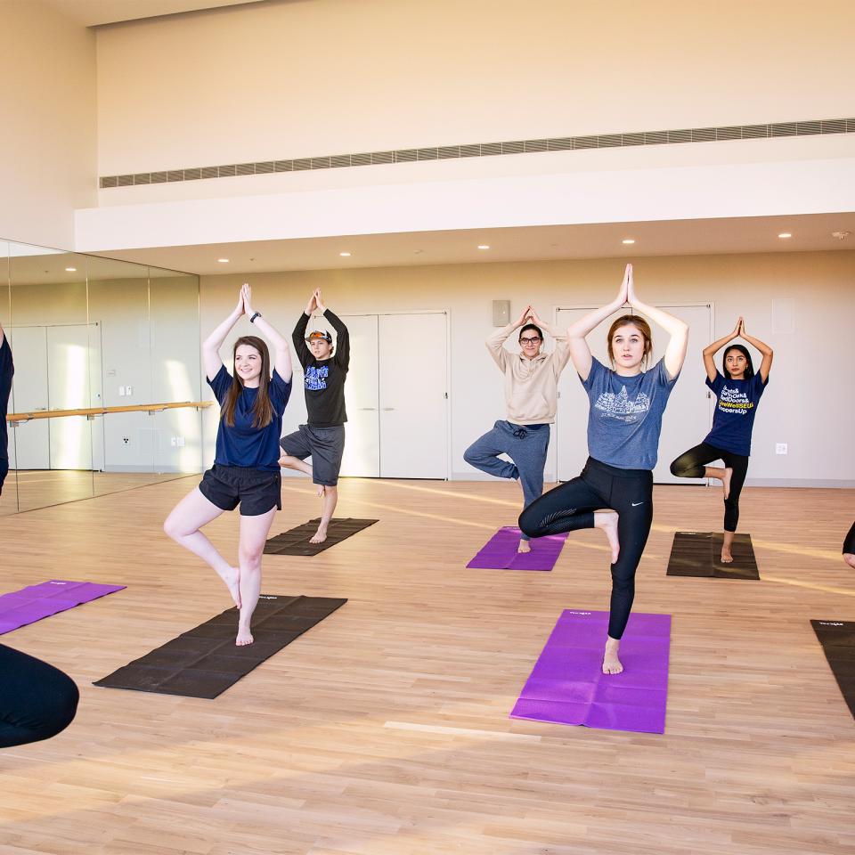 student taking yoga in multipurpose studio 